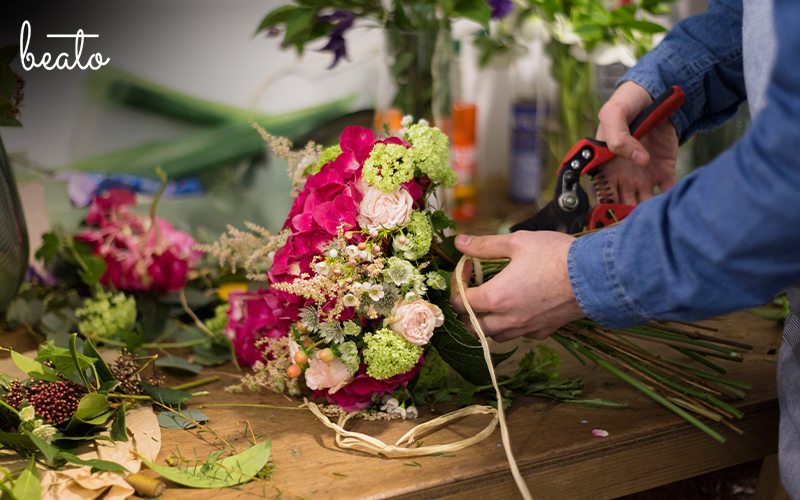 A flower bouquet being arranged.
