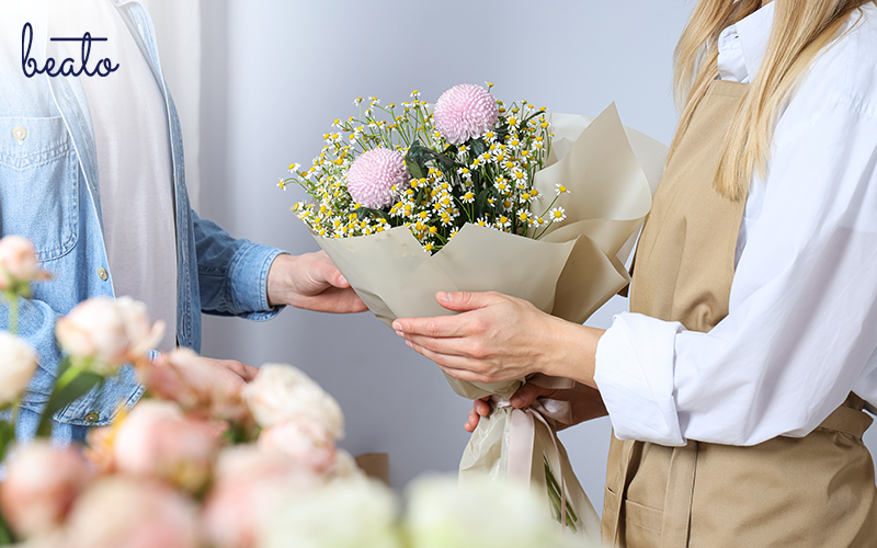 Florist handing over a bouquet of flowers