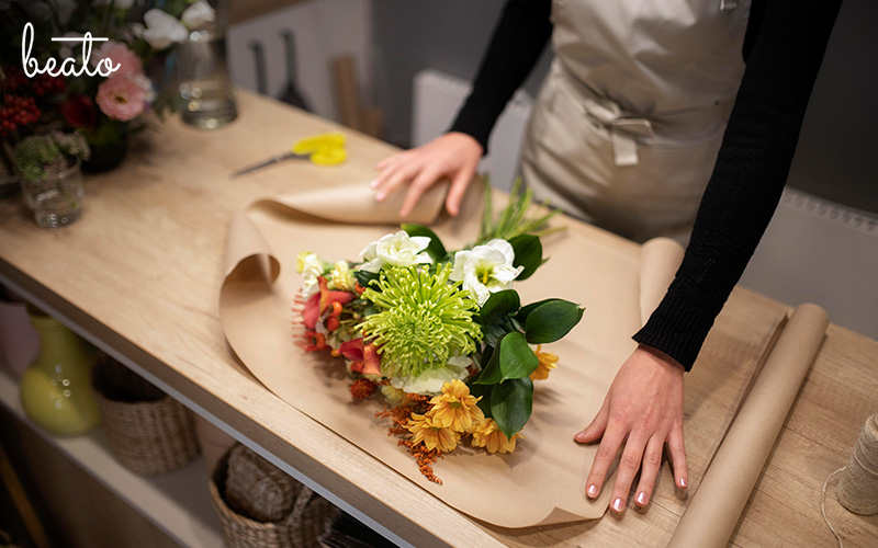 person creating their own flower bouquet