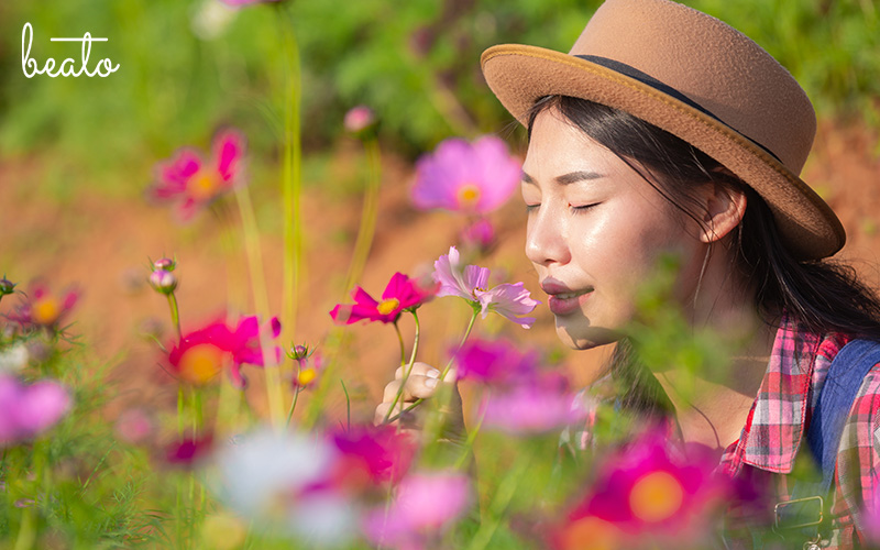 woman smelling a flower